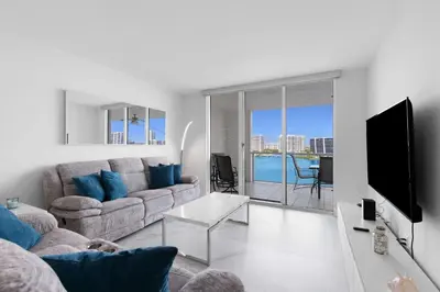 a living room with a couch and a tv at Le Marina Bay PH3 STR-01487 in Sunny Isles Beach