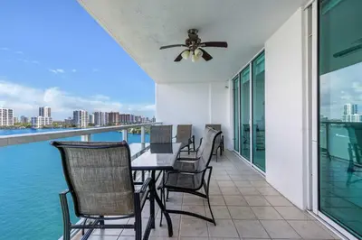 a balcony with a table and chairs and the water at Le Marina Bay PH3 STR-01487 in Sunny Isles Beach