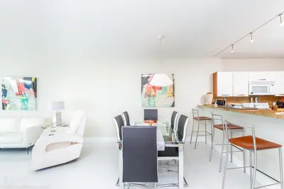a living room with white furniture and a counter at Le Marina Bay PH4 STR-01484 in Sunny Isles Beach