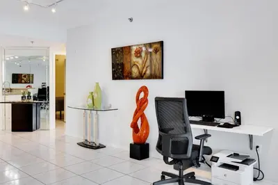 an office with a desk with a computer and an orange sculpture at Les Pelicans #316 STR-02743 in Sunny Isles Beach