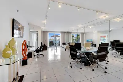 an office with a desk and chairs and a table at Les Pelicans #316 STR-02743 in Sunny Isles Beach