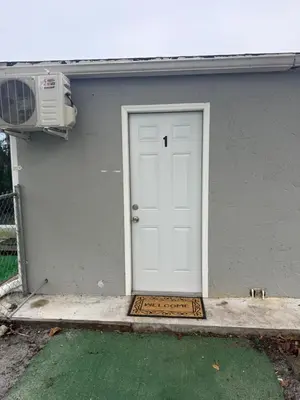 a white door of a house with a air conditioner at Modern private efficiency Miami Gardens in Miami Gardens