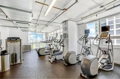 a gym with treadmills and cardio machines in a building at Modern 2-BD Condo in Midtown Miami Pool & Gym in Miami