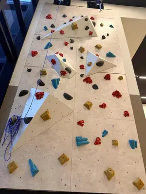 a rock wall with colorful debris on a table at District 225 in Miami