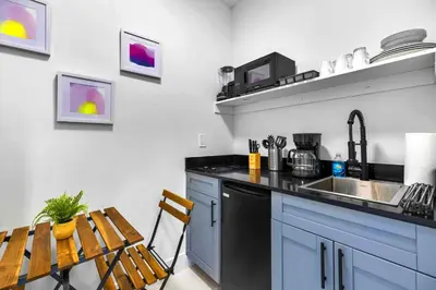 a kitchen with a counter and a sink and a table at Comfy Studio W Essentials Near Airport in Miami