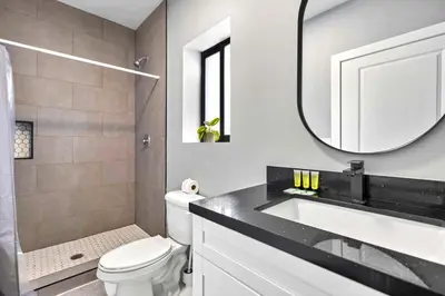 a bathroom with a sink and a toilet and a mirror at Comfy Studio W Essentials Near Airport in Miami