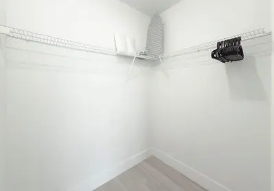 a room with white walls and a shelf with wine bottles at Bright 1BR Miami Beach Apt with 3 Queens & Smart TV in Miami Beach