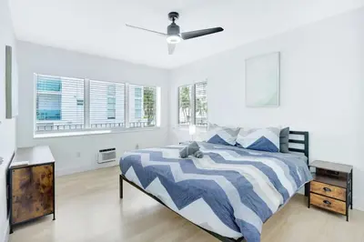 a bedroom with a bed and a ceiling fan at 1BR Miami Beach Apt with King plus 2 Queens & Parking in Miami Beach