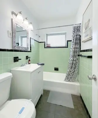 a bathroom with a toilet and a tub and a sink at 1BR Miami Beach Apt with King plus 2 Queens & Parking in Miami Beach