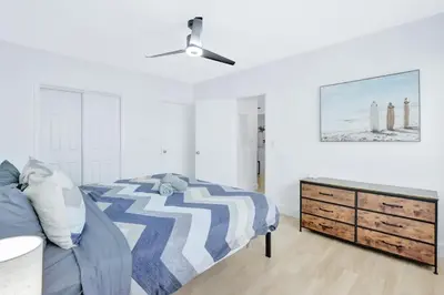 a bedroom with a bed and a dresser at 1BR Miami Beach Apt with King plus 2 Queens & Parking in Miami Beach