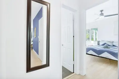 a mirror in a bedroom next to a bed at 1BR Miami Beach Apt with King plus 2 Queens & Parking in Miami Beach