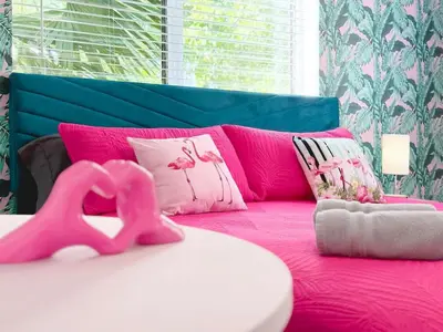a pink bed with pink pillows and a pink horse on it at Modern Miami Beach Studio with King Bed in Miami Beach