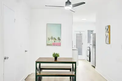 a dining room with a table and a ceiling fan at Bright 1BR Miami Beach Stay Near the Ocean in Miami Beach