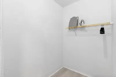 a bathroom counter with a sink and a shelf at Sunny Miami Beach Studio with 2 Queens plus Workspace in Miami Beach