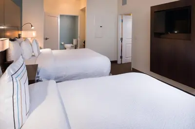 a hotel room with two beds and a flat screen tv at Residence Inn by Marriott Miami West/FL Turnpike in Miami