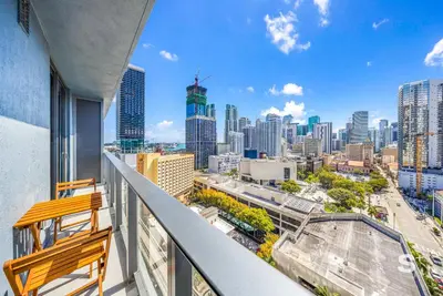 a balcony with a bench and a view of the city at Downtown Miami - Luxury Condo with City Views in Miami