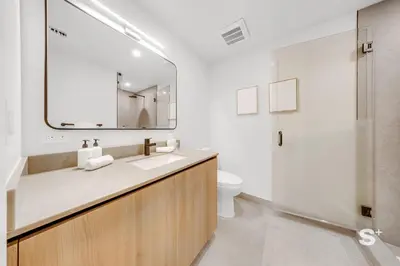 a bathroom with a sink and a mirror and a toilet at Cozy and Spacious Studio in Miami City Views in Miami