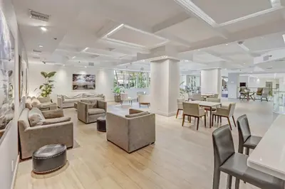 a living room with couches and chairs and tables at Miami Beach Studio with shared Heated Pool & Gym in Miami Beach