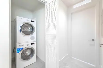 a white laundry room with a washer and dryer at Modern Escape in Brickell w Pool & Gym in Miami