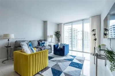 a living room with a yellow chair and a couch at Miami Getaway in Icon Brickel 1BR in Downtown Miami in Miami