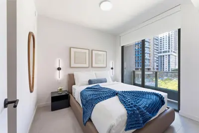 a bedroom with a large bed and a large window at 501 First Residences in Miami