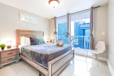 a bedroom with a large bed and a balcony at Bright Escape Near Hot Spots in Miami