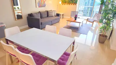 a living room with a table and chairs and a couch at Bright Escape Near Hot Spots in Miami