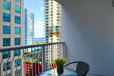 a balcony with a table and a view of a building at Studio W Panoramic Views Prime Comfort in Miami
