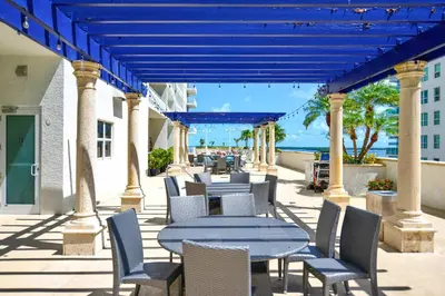 a patio with tables and chairs and the ocean at Studio W Panoramic Views Prime Comfort in Miami