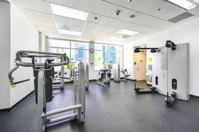 a gym with treadmills and machines in a room at Studio W Panoramic Views Prime Comfort in Miami