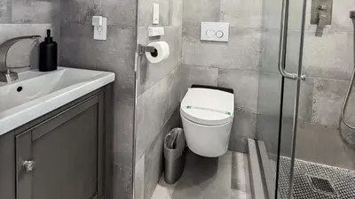 a bathroom with a toilet and a sink at Great 2BR Condo-DIRECT BEACH ACCESS Pool, Gym and FREE Parking in Hollywood