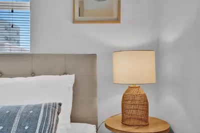 a lamp sitting on a table next to a bed at Oceanfront Residence by Atlantikos in Hollywood