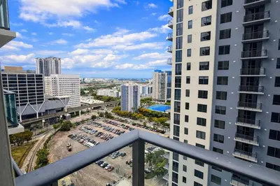 a balcony view of a parking lot in a city at Lujoso apartamento ,The Crosby Miami World Center in Miami