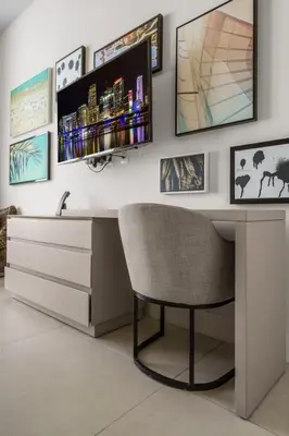 a desk with a chair and a television on a wall at Lyfe Resort Ocean View Gym Direct Beach Access in Hollywood