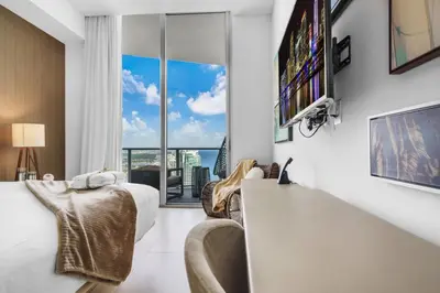 a living room with white furniture and a large window at Lyfe Resort Ocean View Gym Direct Beach Access in Hollywood