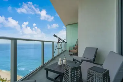 a balcony with a view of the ocean and a telescope at Lyfe Resort Ocean View Gym Direct Beach Access in Hollywood