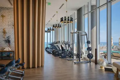 a gym with a row of treadmills and ellipticals at Lyfe Resort Ocean View Gym Direct Beach Access in Hollywood