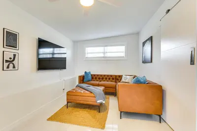 a living room with a couch and a television at 3 Mi to Sea! Family Pool House in Fort Lauderdale in Fort Lauderdale