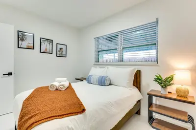 a bedroom with a white bed and a window at 3 Mi to Sea! Family Pool House in Fort Lauderdale in Fort Lauderdale