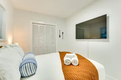 a bedroom with a bed with a tv on the wall at 3 Mi to Sea! Family Pool House in Fort Lauderdale in Fort Lauderdale