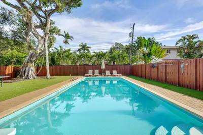 a swimming pool in a yard with a fence at 3 Mi to Sea! Family Pool House in Fort Lauderdale in Fort Lauderdale