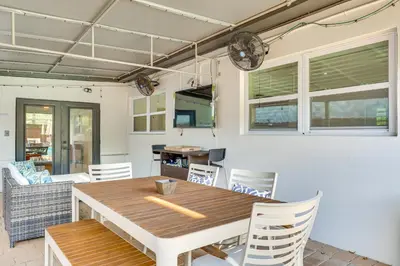 a dining room with a wooden table and chairs at 3 Mi to Sea! Family Pool House in Fort Lauderdale in Fort Lauderdale