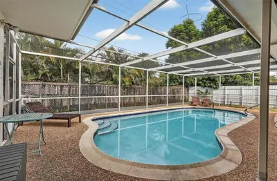 a large swimming pool with an open roof at Spacious 3BR Home with Private Pool in Hollywood in Hollywood
