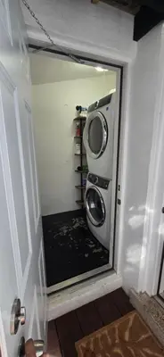 a washing machine in a room with a mirror at Cozy private 2BR Home with Outdoor space and BBQ grill in Hollywood