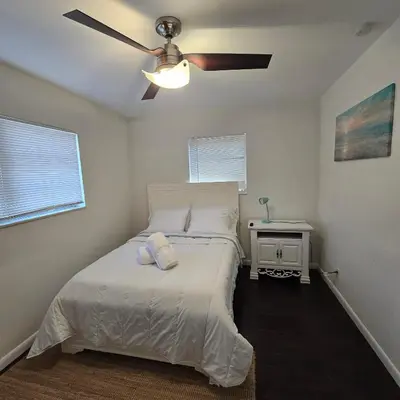 a bedroom with a bed with a ceiling fan at Cozy private 2BR Home with Outdoor space and BBQ grill in Hollywood