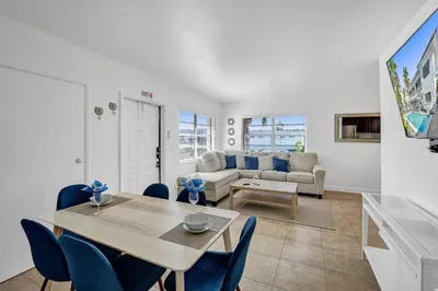 a living room with a table and a couch at Desoto Beach Retreat with Heated Pool - By Atlantikos in Hollywood