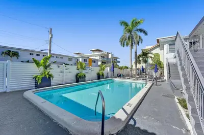 a swimming pool in front of a house at Desoto Beach Retreat with Heated Pool - By Atlantikos in Hollywood