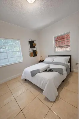 a bedroom with a large bed and a window at Cassa Wynwood in Miami