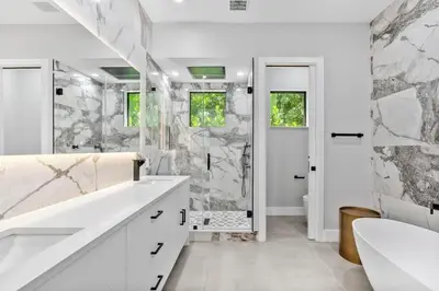 a white bathroom with a shower and a sink at New construction Fort Lauderdale luxury villa with Pool in Fort Lauderdale