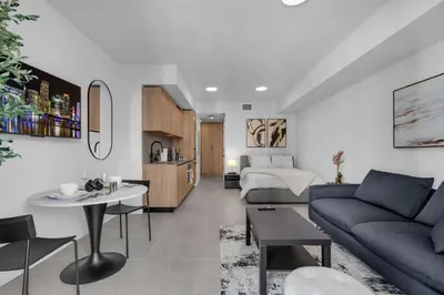 a living room with a couch and a bed at Brand New Modern Downtown Studio at Prime Location in Miami